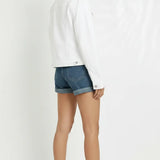 Side and back angle of women's white denim trucker jacket showing silhouette and cuffed sleeves