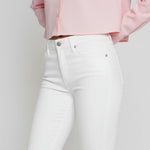 Studio shot of model standing straight in women's white bootcut denim jeans
