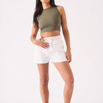 A woman posing in a casual white jogger shorts outfit