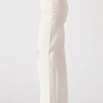 White pants worn by a person on a white background