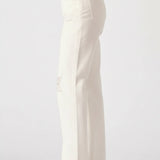 White pants worn by a person on a white background
