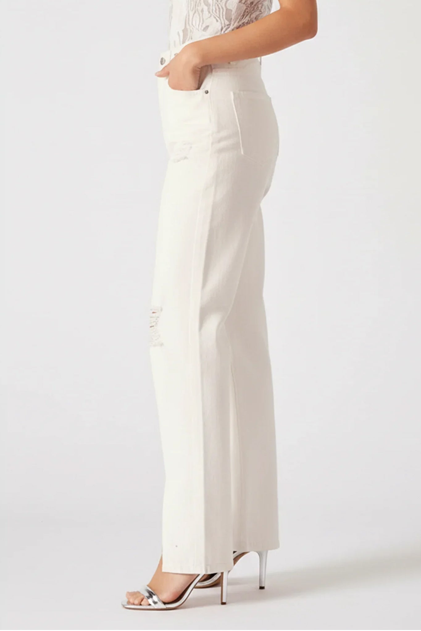 White pants worn by a person on a white background
