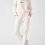 A woman posing in a white sweatshirt for women with a casual fit