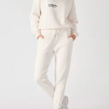 A woman posing in a white sweatshirt for women with a casual fit