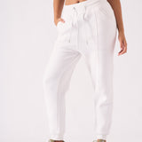A woman wearing a stylish white tapered jogger womens in a front view.
