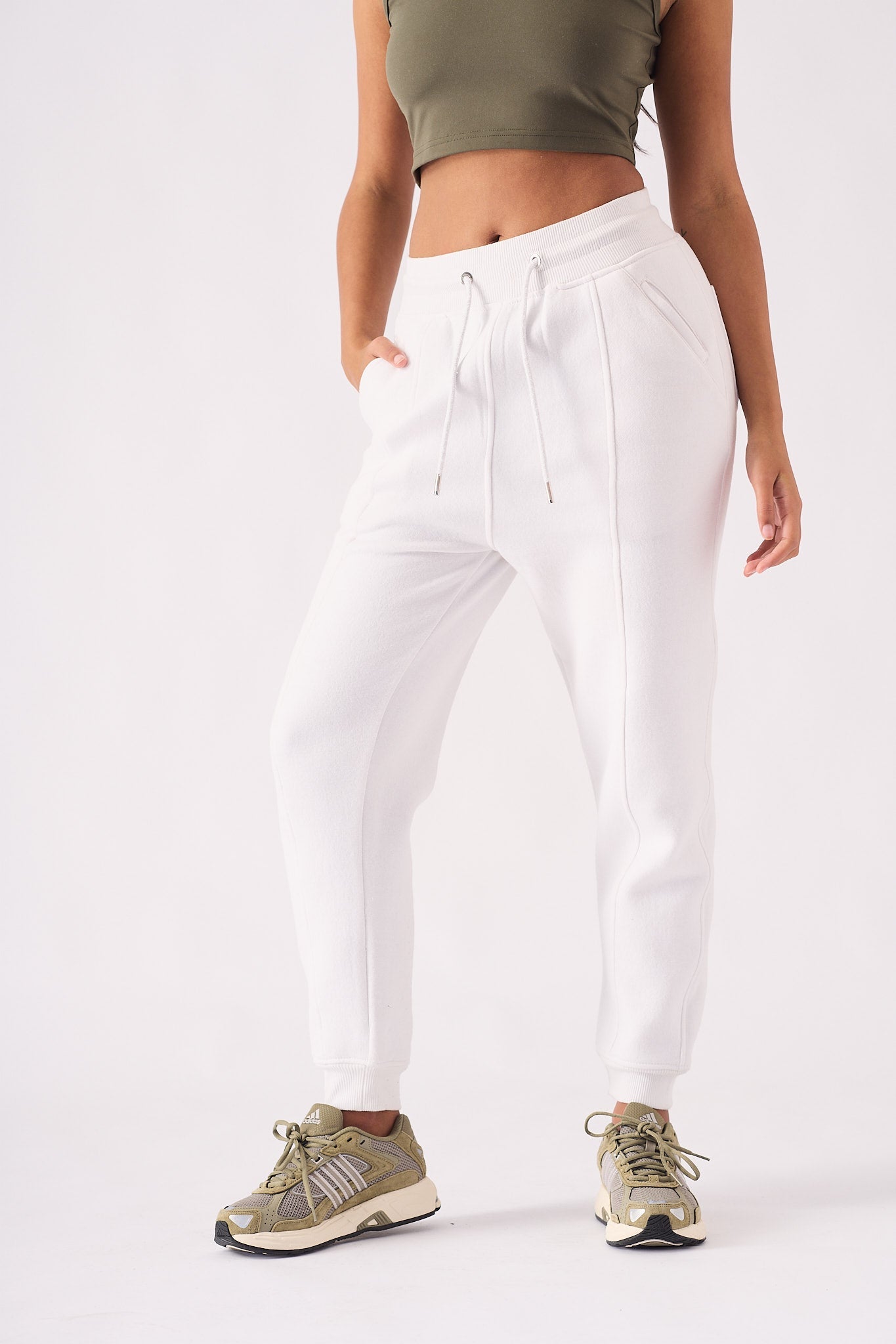 A woman wearing a stylish white tapered jogger womens in a front view.