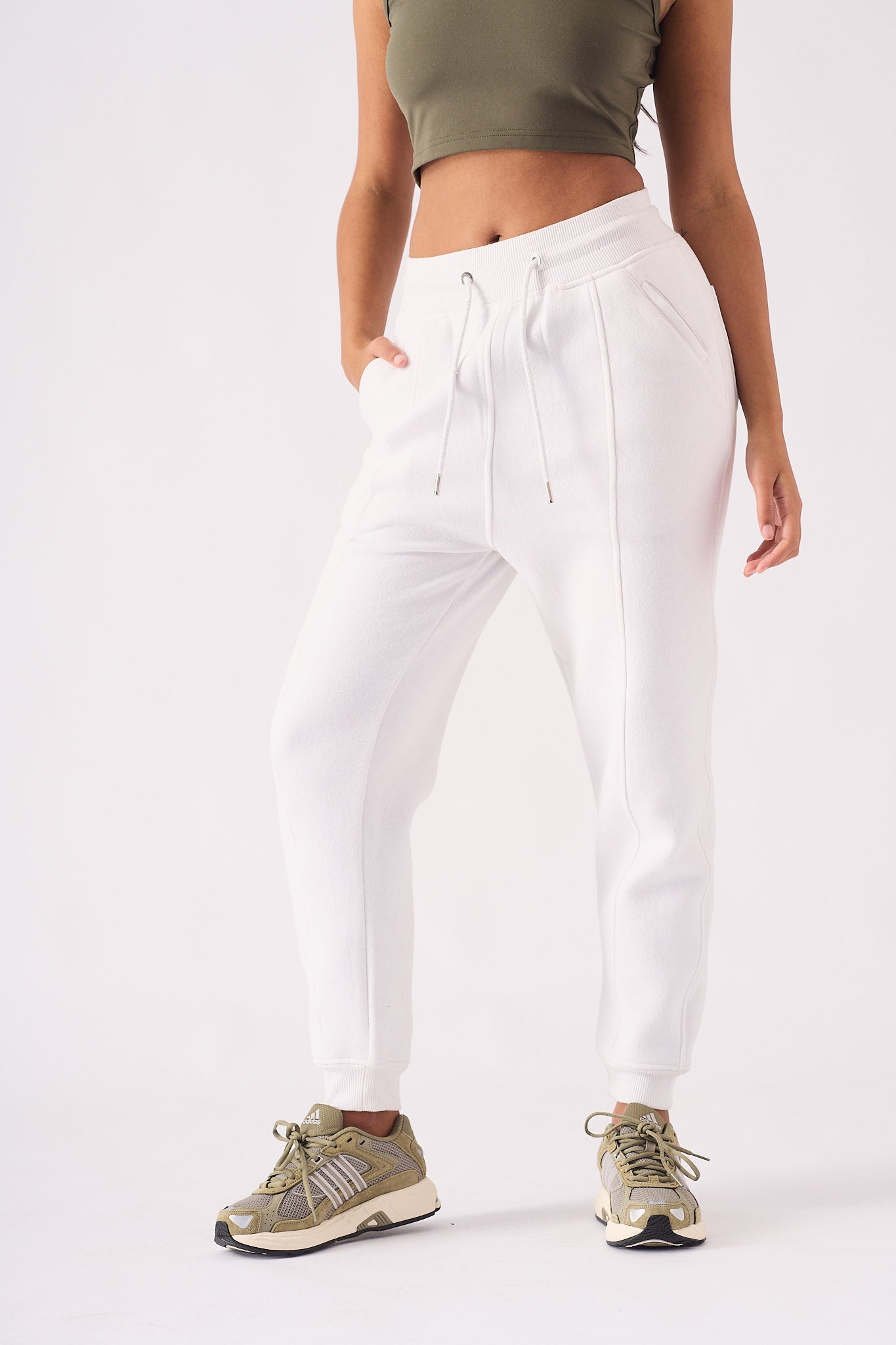 A woman wearing a stylish white tapered jogger womens in a front view.