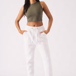 A model posing in white tapered jogger womens for a clean loungewear look.