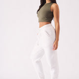 Side profile of a model wearing a comfortable white tapered jogger womens.