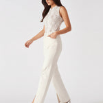 Model walking in white wide-leg trousers demonstrating the fabric drape and movement.