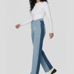 Model walking in high-waisted color-block jeans showing the wide leg silhouette