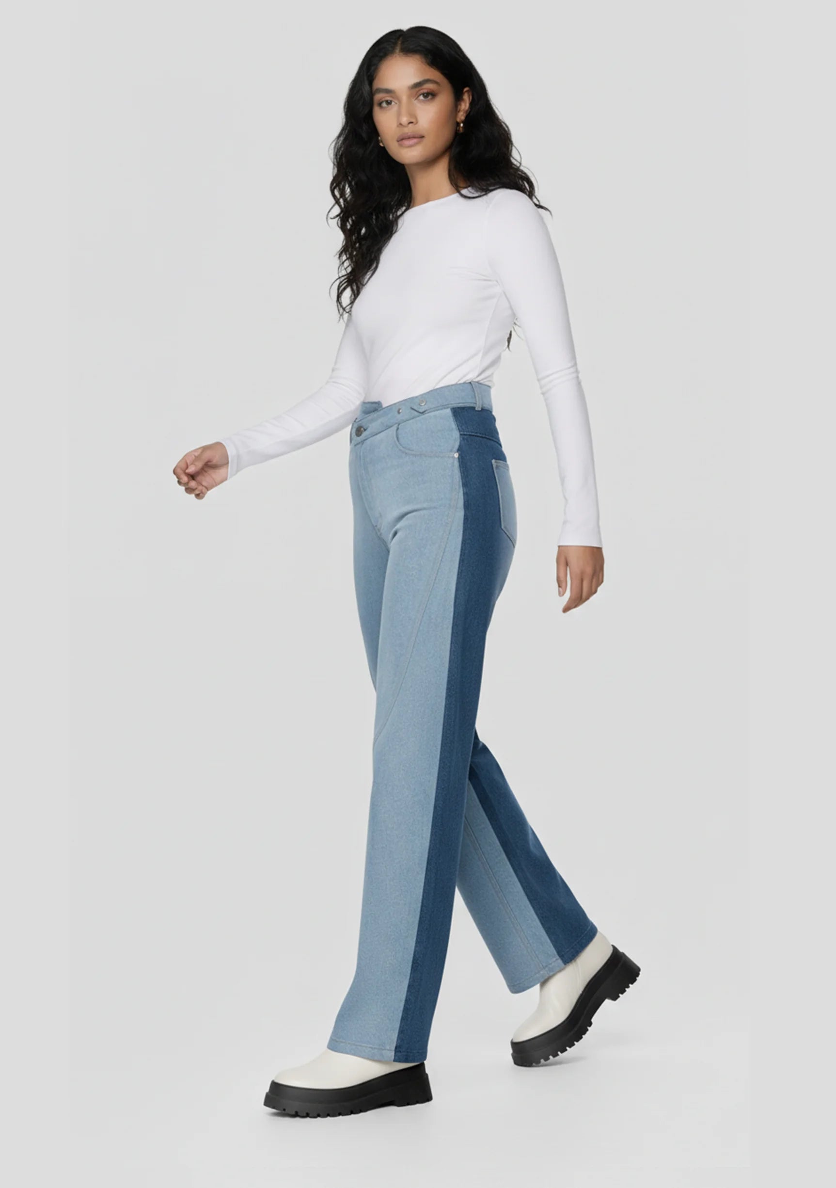Model walking in high-waisted color-block jeans showing the wide leg silhouette
