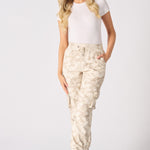 Full body shot of a model wearing tie dye cuffed cargo joggers and trainers