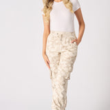 Full body shot of a model wearing tie dye cuffed cargo joggers and trainers