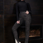 A model wearing high-waisted black acid wash jeans for a complete look