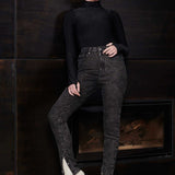 A model wearing high-waisted black acid wash jeans for a complete look