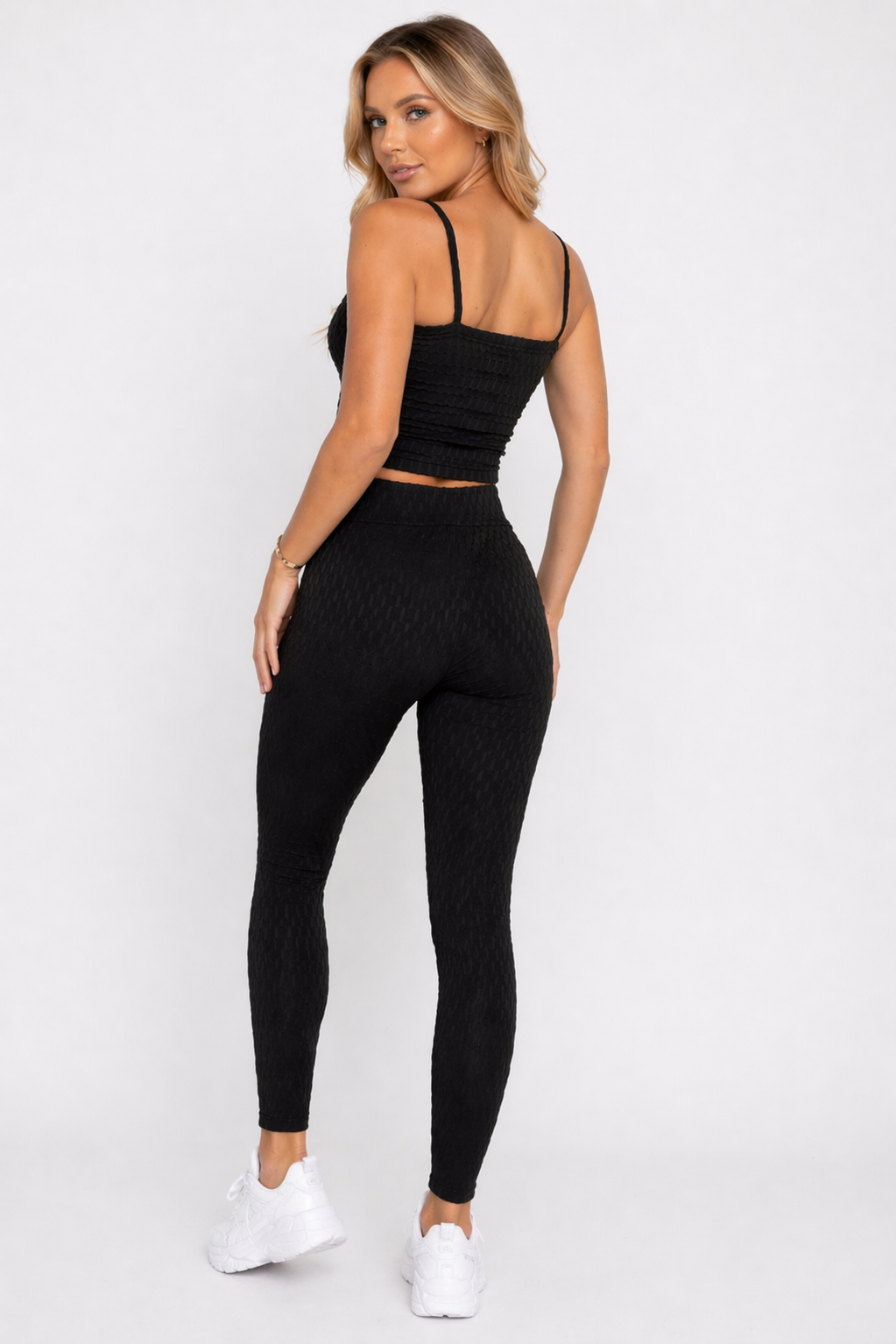A woman wearing womens-black-bubble-texture-leggings back view showing the raised bubble texture and high waist fit