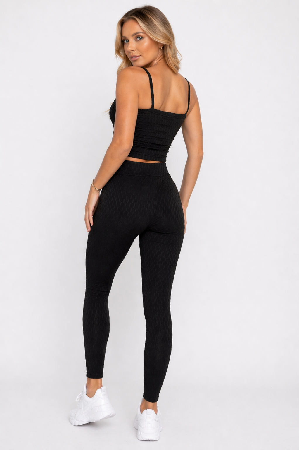A woman wearing womens-black-bubble-texture-leggings back view showing the raised bubble texture and high waist fit