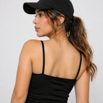 A woman wearing womens-black-ribbed-crop-top back view showing the thin straps and fitted cut