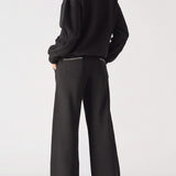 Rear view of a black crew neck jumper for women with relaxed shoulders