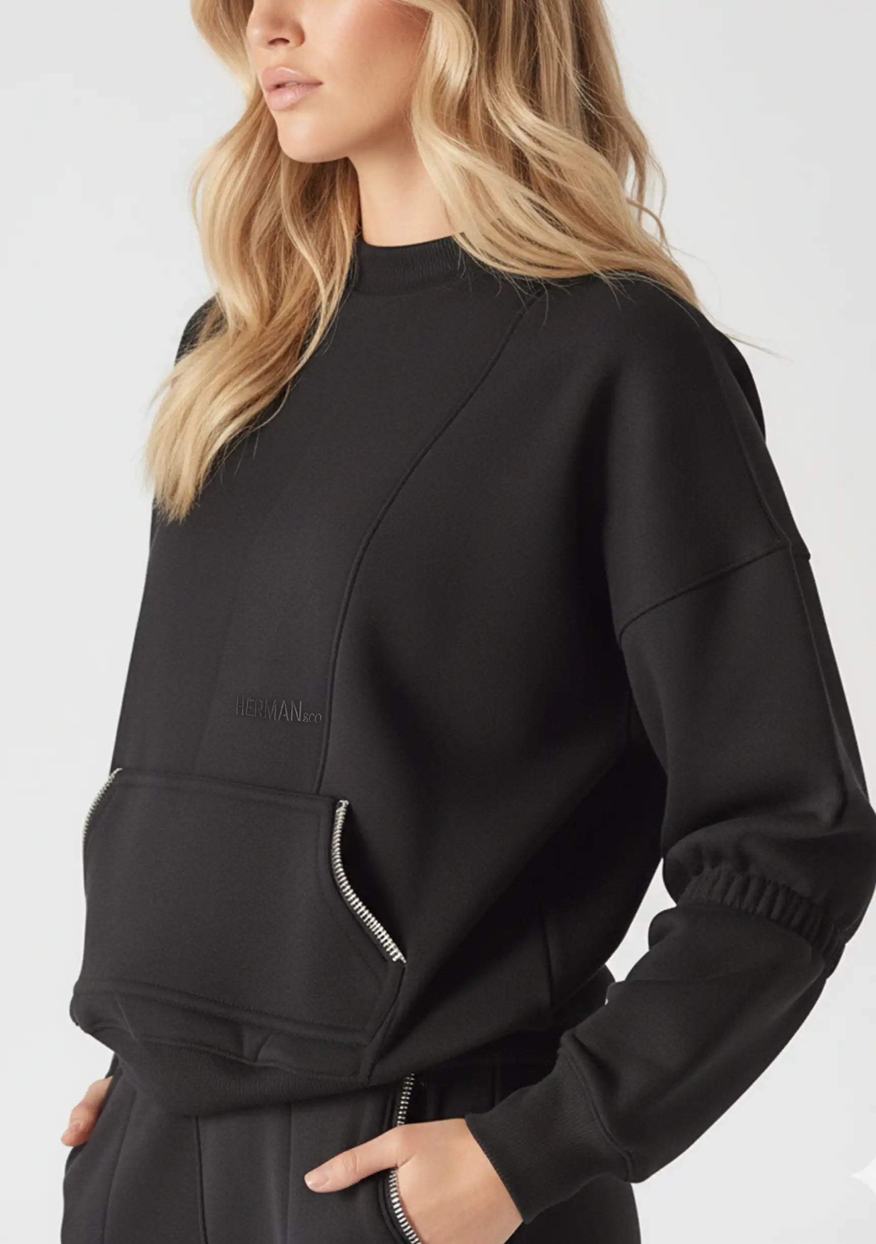 Side view of black crew neck jumper showing the unique ruched sleeve design