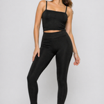 A woman wearing womens-black-ribbed-crop-top styled casually showing how it works layered or worn alone