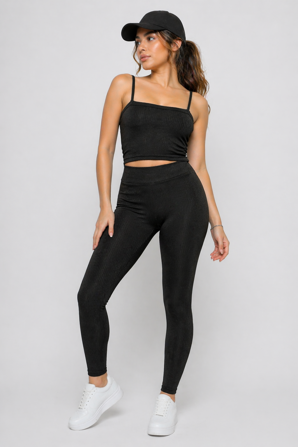 A woman wearing womens-black-ribbed-crop-top styled casually showing how it works layered or worn alone
