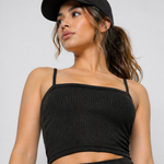 A woman wearing womens-black-ribbed-crop-top standing view showing the cropped length and fitted body skimming fit
