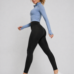  A woman walking in womens-black-fitted-high-waist-leggings with a deep waistband, side view showing shape and fit