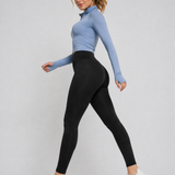 A woman walking in womens-black-fitted-high-waist-leggings with a deep waistband, side view showing shape and fit