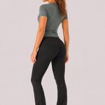 A woman wearing womens-black-kick-flare-leggings back view showing the butt lifting shaping fit and kick flare length