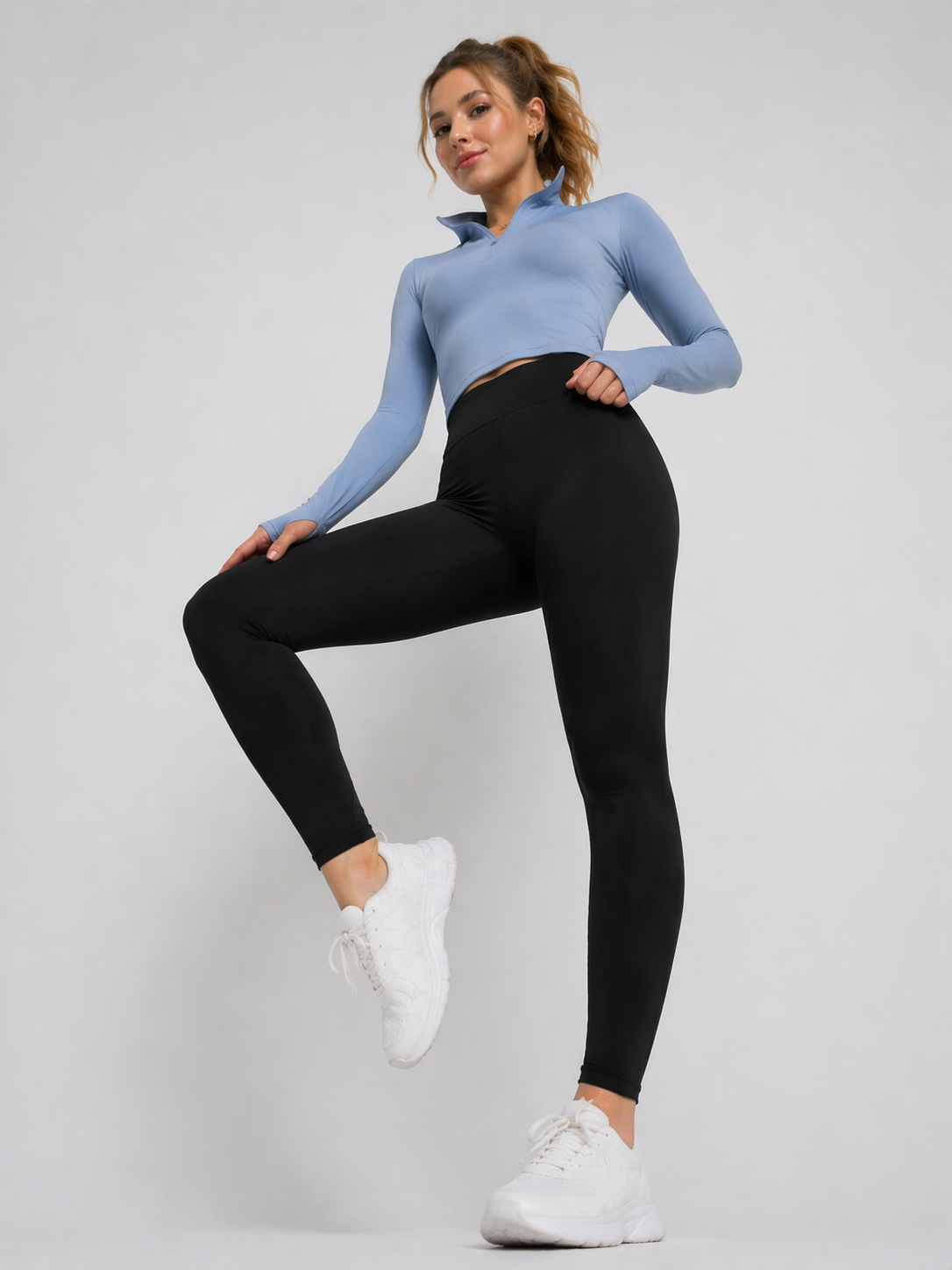 A woman in womens-black-high-waist-stretch-leggings lifting her knee, showing full range of movement in an active pose