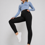 A woman in womens-black-high-waist-stretch-leggings lifting her knee, showing full range of movement in an active pose