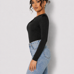 Side view of a woman in a Women's Black One Shoulder Ruched Fitted Bodysuit with blue jeans