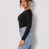Side view of a woman in a Women's Black One Shoulder Ruched Fitted Bodysuit with blue jeans