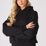 Close up shot of the dropped shoulder seam on a black oversized hoodie