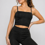 A woman wearing womens-black-ribbed-crop-top in a relaxed standing pose showing the natural drape of the fabric