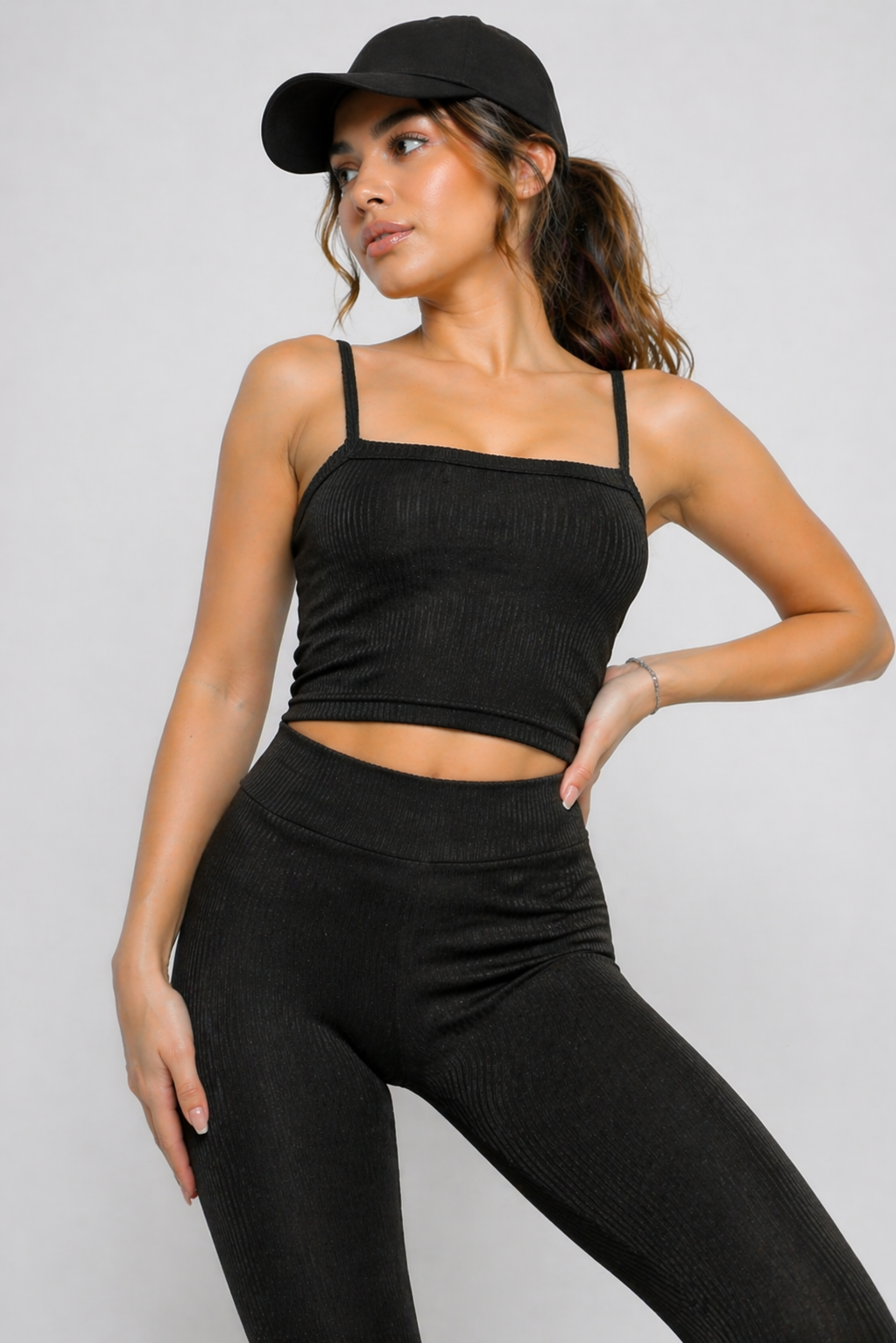 A woman wearing womens-black-ribbed-crop-top in a relaxed standing pose showing the natural drape of the fabric