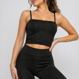 A woman wearing womens-black-ribbed-crop-top in a relaxed standing pose showing the natural drape of the fabric