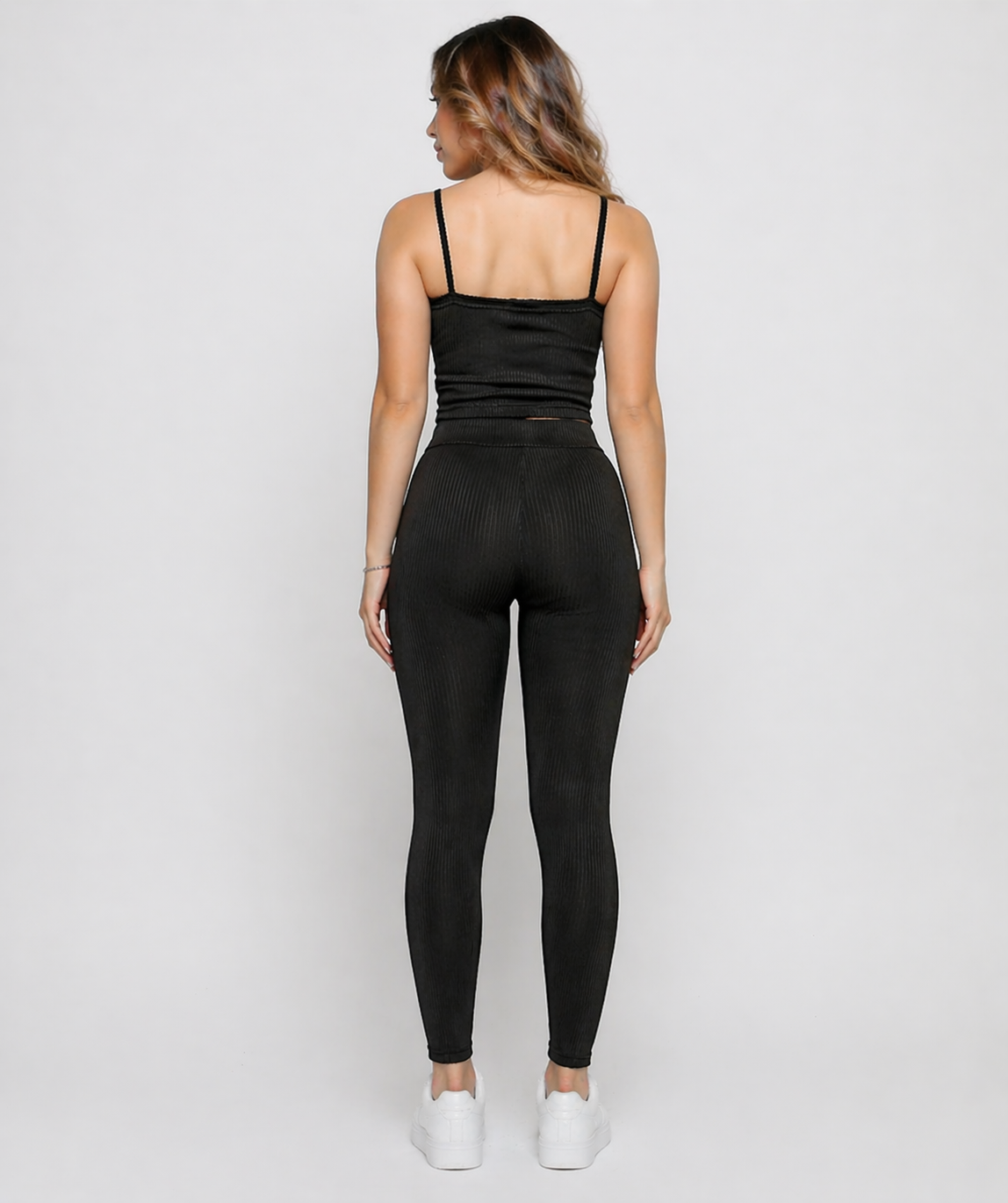 Full length back view of a woman in Women's Black Ribbed High Waist Leggings with matching co-ord top