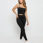 A woman posing in Women's Black Ribbed High Waist Leggings and matching ribbed cami crop top co-ord set