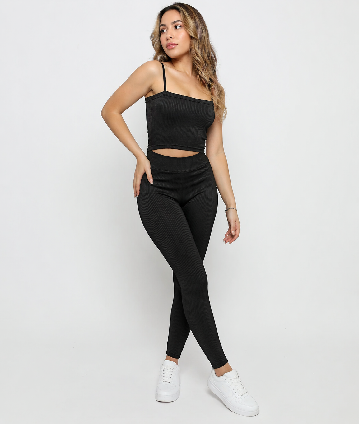 A woman posing in Women's Black Ribbed High Waist Leggings and matching ribbed cami crop top co-ord set