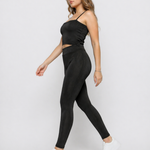 Side view of a woman walking in Women's Black Ribbed High Waist Leggings with co-ord cami crop top