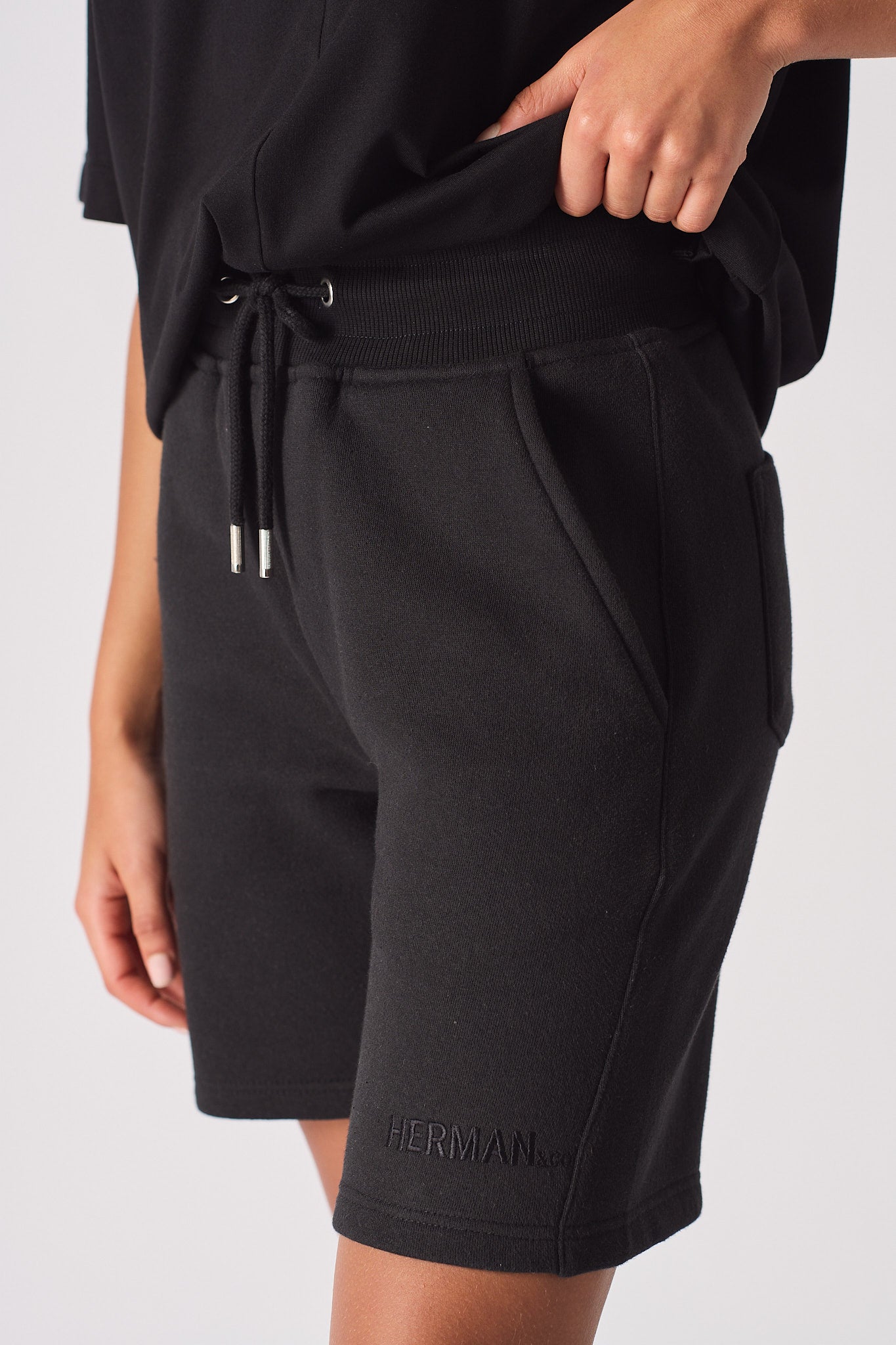 womens black sweat shorts logo embroidery hem detail