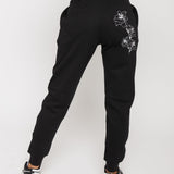 Back view of the women's black tapered joggers with white floral embroidery