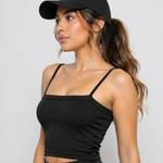A woman wearing womens-black-ribbed-crop-top side view showing the fitted silhouette and ribbed texture detail