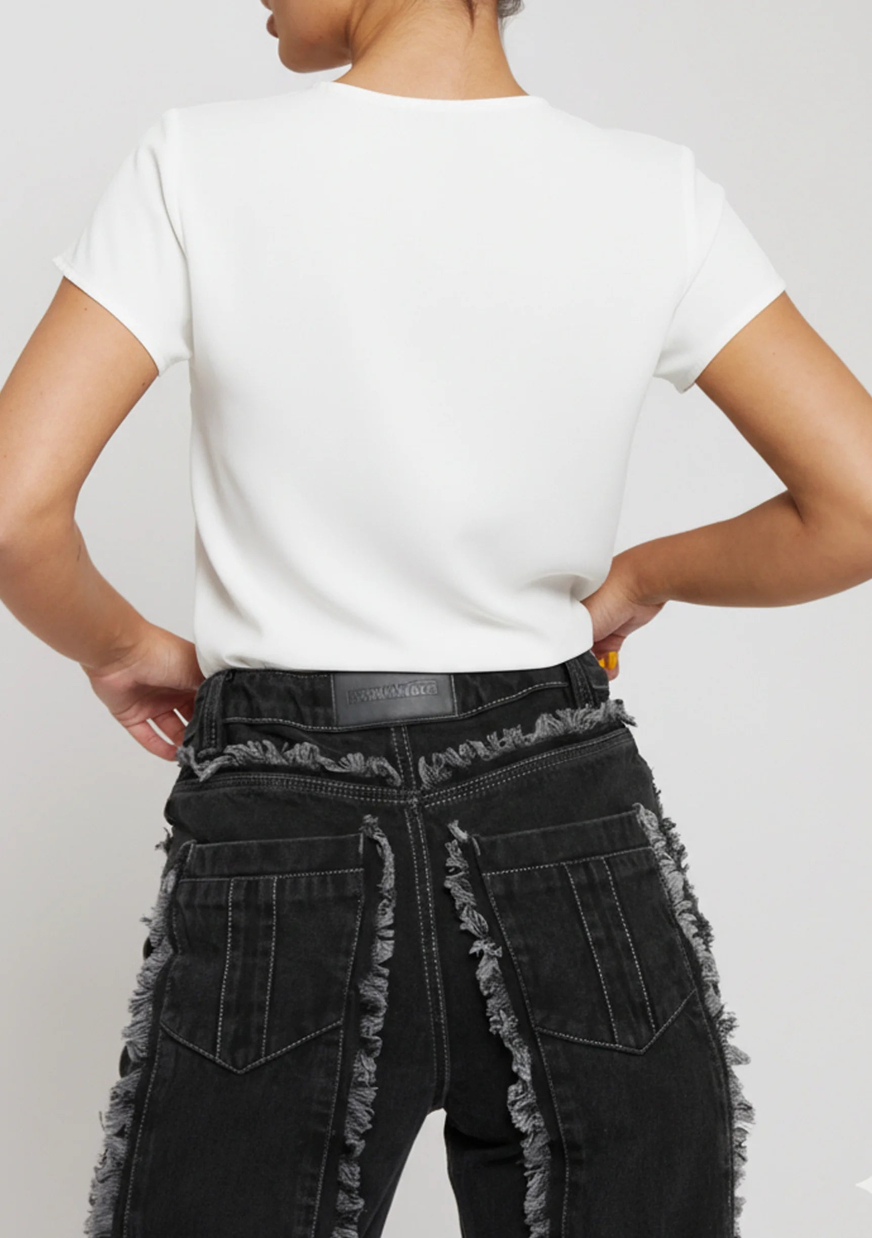 Close up of back pocket and frayed seam on Womens Black Wash jeans