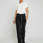 Model walking in Womens Black Wash frayed seam straight leg jeans