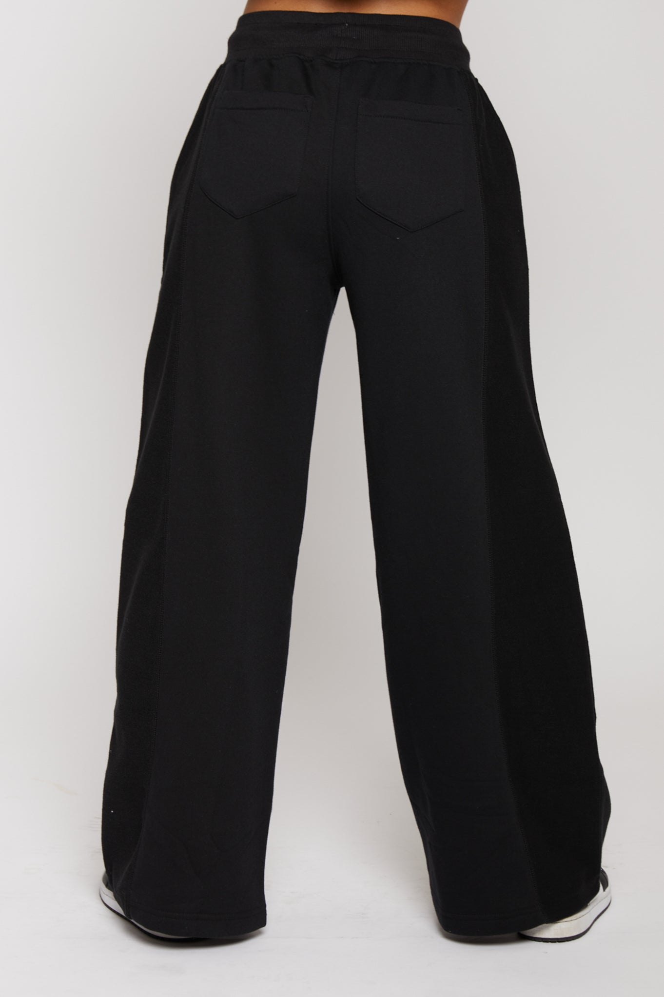Back view of high waisted black wide leg joggers showing the relaxed fit