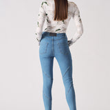 Back view of a model in the women's blue high-waisted skinny jeans.
